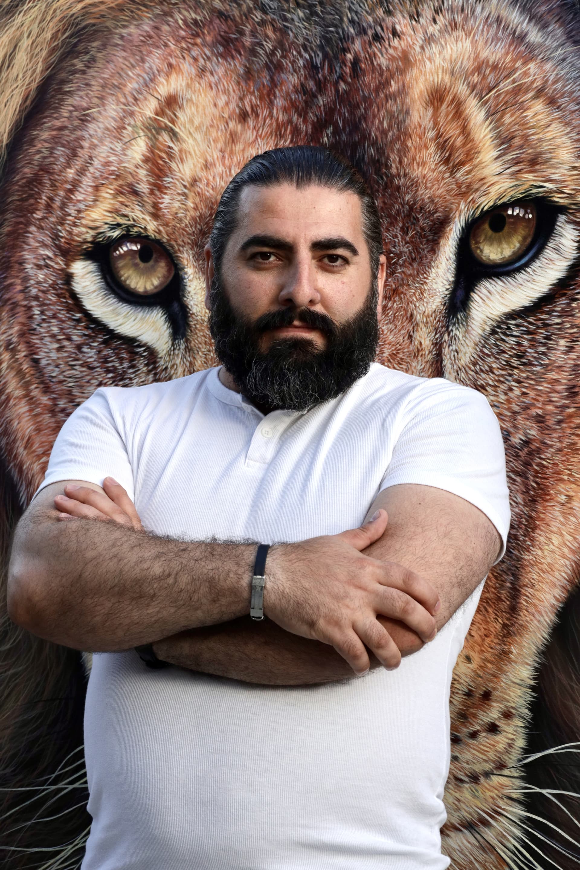 Portrait of Artak Hambardzoumyan with a hyperrealistic tiger artwork in the background